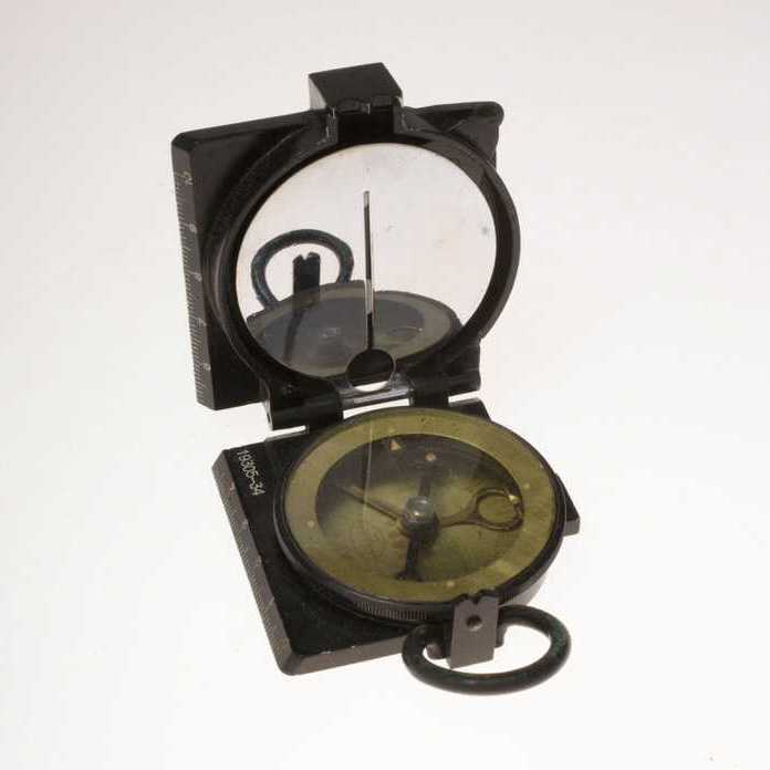 A black compass inside a folding case with a ruler edge.