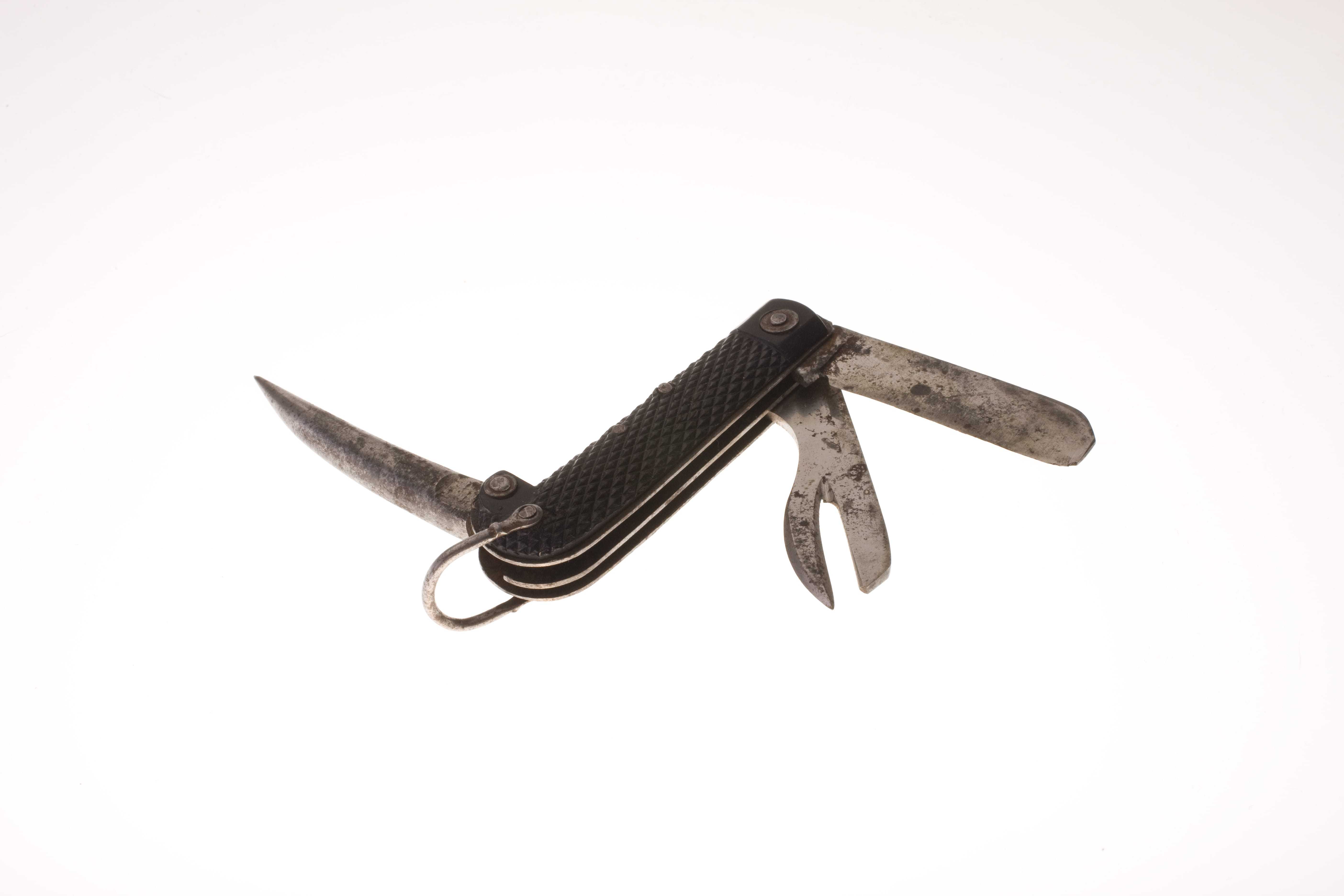 A black handle with a blade and two other tools hinging out from the ends