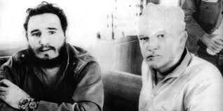 A black and white photograph of Castro and James sitting next to one another.