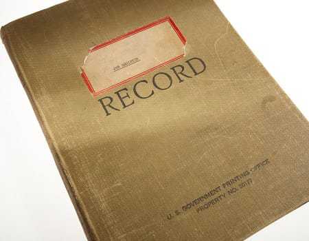 A closed book with "Record" and "US Government Printing Office Property No. 50177" printed on the cover. A sticker on the cover reads "Job Register."