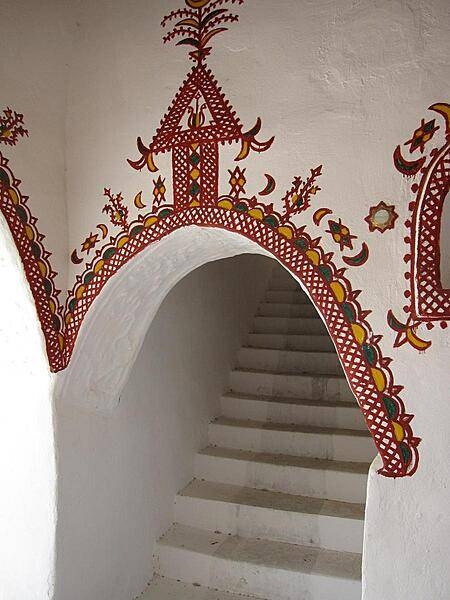 The traditionally decorated mud brick architecture of Ghadames' Old City is designed for natural cooling. Buildings are built directly adjacent to each other, which insulates the streets and living spaces below from the beating sun.