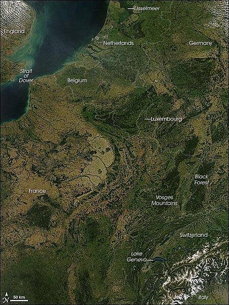 A rare cloud-free view of a wide area of Western Europe. This Aqua satellite image was captured on 30 August 2008. Skies were clear from the Netherlands in the north to Italy in the south, revealing several of Europe's famous natural and man-made features. A few small fires (marked with red dots) were detected, as well.
A pair of geologically matching mountain ranges appear at the border of France and Germany, covered in dark green forests. France's Vosges and Germany's Black Forest rise on either side of the Rhine River Valley. The valley in that area is known to geologists as the Rhine Graben; a graben is an elongated block of Earth's crust that has sunk relative to surrounding blocks. To the south, the snow-covered Alps create an arcing boundary between Switzerland and Italy.
Near the bottom right of the image, one of the largest lakes in Europe, Lake Geneva (formally known as Lac Leman), fills a glacier-carved valley in western Switzerland. This natural lake occurs on the Rhone River, upstream of where it makes a sharp southward bend as it leaves the Alps. At the northern edge of the image is a larger, artificial lake: the Netherland's IJsselmeer. Despite its closeness to the North Sea, IJsselmeer is a freshwater lake. It was originally a saltwater inlet at the mouth of the IJssel River, but in the early 1930s, the Dutch built a dike across the inlet. The freshwater flow of the IJssel River flushed out the seawater, forming the new lake. Photo courtesy of NASA.