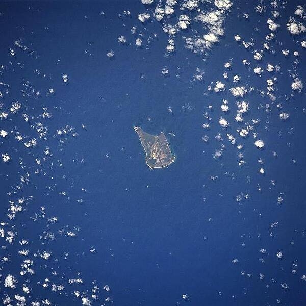The largest of the three Volcano Islands, Iwo Jima is seen here from the north. The island is about 8 km (5 mi) long and 4 km (2.5 mi) wide, and covers an area of 21 sq km (8 sq mi). Mount Suribachi (167 m; 546 ft high), on the south side of the island, is an extinct volcano. Iwo Jima was the scene of one of the bloodiest battles in the Pacific Theater of World War II. Image courtesy of NASA.