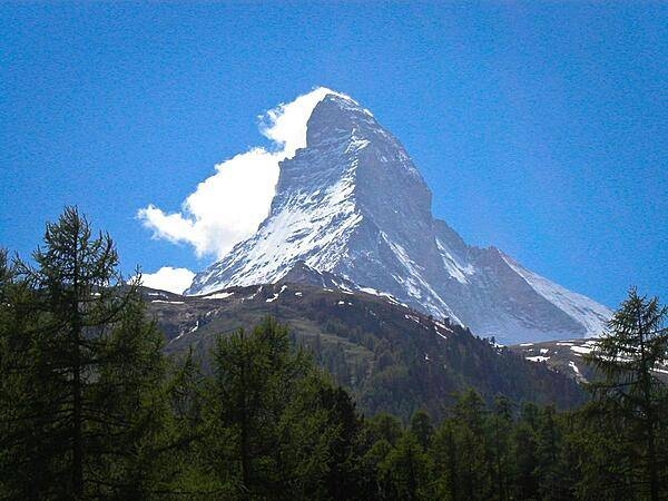 The Matterhorn is a pyramidal mountain on the border between Switzerland and Italy. Its summit is 4,478 m (14,692 ft) high, making it one of the highest, most famous, and deadliest peaks in the Alps. The steep faces, oriented to each compass point, cause regular avalanches; the snow that builds up around the base forms glaciers. Mountains around the world with similar profiles frequently earn "Matterhorn" as a nickname because of the mountain's iconic shape.