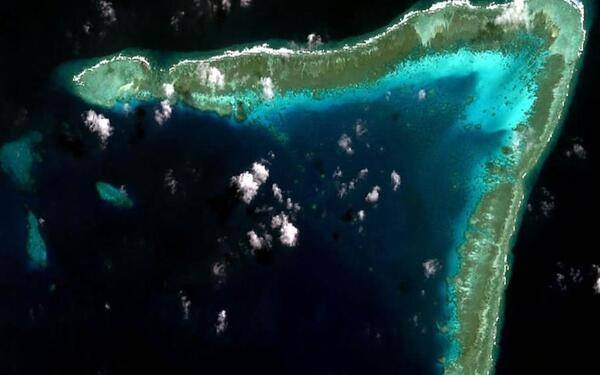 A 2011 view from space of Whitson Reef in the Spratly Islands. Whitson is the largest reef of the Union Banks and lies at their northeastern most extreme limit. The reef is claimed by China, the Philippines, and Vietnam. Image courtesy of NASA.