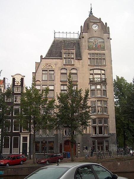 The Astoria building in Amsterdam in the Netherlands, built in 1904-05, is a reserved style of Art Nouveau (Jugendstil) that came to be known as "New Art" (Nieuwe Kunst). Typical Art Nouveau engravings appear in the grey stone around the doorway.
