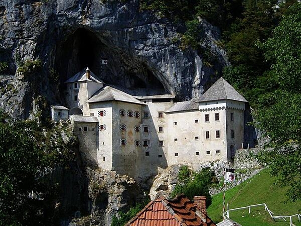 Predjama Castle is built on one of the world’s most unusual sites for a fortification, in the mouth of a cave complex that is halfway up a 123-m (400-ft) vertical cliff face in southwest Slovenia. The first two castles on the site were destroyed in a siege and an earthquake, respectively. In 1570, the present Renaissance-style structure was built below the original medieval castle.