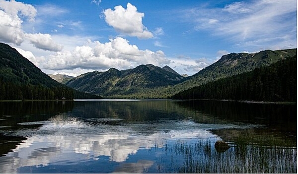 Lake Rakhmanov lies in the Altai Mountains of eastern Kazakhstan, in Katon-Karagay National Park. The lake's temperature is always low due to its depth, location, and ice-cold tributaries. The lake is fed by warm thermal springs containing radon and nitrogen.