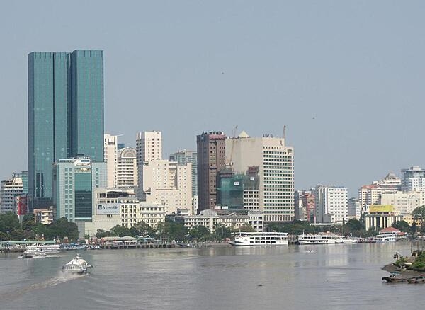 View of Ho Chi Minh City (aka Saigon) from the Saigon River. Saigon is Vietnam&apos;s major port and, with 8 million inhabitants, its largest city. It was called Saigon until 1975 when it was renamed Ho Chi Minh City following its capture by North Vietnamese communist forces. Although the city&apos;s commercial core is officially called Saigon, the entire city is widely referred to as Saigon even in the North. The city was architecturally influenced by the French during their colonial occupation of Vietnam. Numerous classical Western-style building in the city reflect this, so much so that Saigon was referred to as &quot;The Pearl of the Far East&quot; or &quot;Paris in the Orient.&quot; In more recent years, a building boom has transformed the skyline of the city.