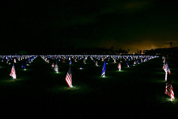 A nighttime display of flags during a Memorial Day flag event. The alternating flags are those of the United States and Guam. Photo courtesy of the US National Park Service.