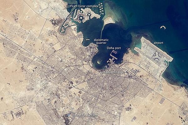 The old and new zones of Doha, the capital city of Qatar, are clearly visible from the International Space Station. The old city comprises the ancient bazaar, or Souq, near the dhow harbor, which is still used today for traditional Arab sailing vessels. Modern port facilities have sprung up to the east of the Souq.

Subsequent developments have sprouted progressively further from the ancient center, with ring roads concentrically arranged around it. The diplomatic quarter is reached via the waterfront Corniche promenade, north of the old city. Further away, an extensive marina known as West Bay Lagoon, with boating access to the Persian Gulf, stands out (image top).

Qatar&apos;s new artificial island, known as the Pearl-Qatar, is under construction with 32 km of new coastline just offshore of West Bay Lagoon. This development is intended mainly as a residential zone, with themes based on Arabic, Mediterranean, and European cultures. The Pearl-Qatar is so named because it is being built on one of Qatar&apos;s historical pearl diving sites. A string of small islands built along the outer margin is intended to recall the pearl-diving culture of the nation&apos;s past. Image courtesy of NASA.