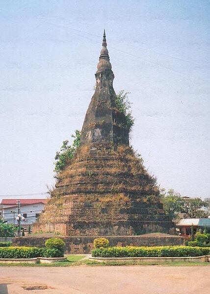 A stupa is a mound-like structure containing Buddhist relics. That Dam ("the black stupa") is one of the oldest Buddhist monuments in Vientiane, Laos.  Legend holds that a seven-headed dragon lives under the stupa and protects the city.