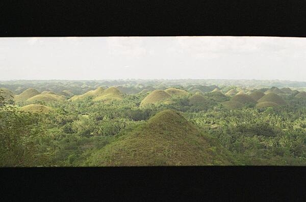 The unusual geological formation known as the Chocolate Hills in Bohol, Philippines, with almost 1,300 cone-shaped hills, all about the same size, spread over about 50 sq km (19 sq mi). The grass covering the hills turns brown during the dry season, giving the hills their name.