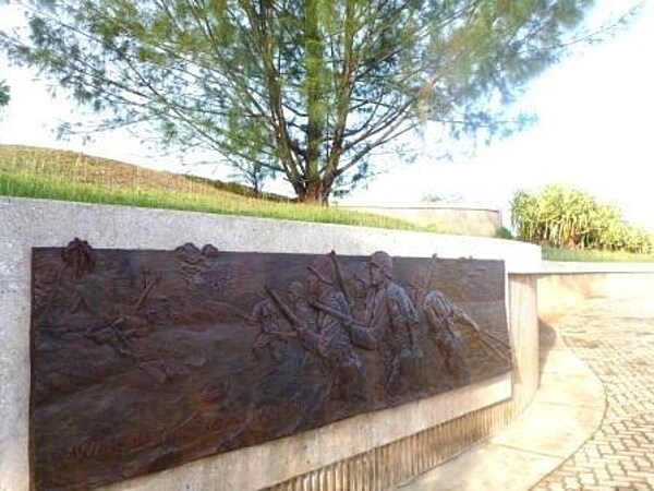 Bronze relief on a memorial at the War in the Pacific National Historical Park. Established in 1978, the Park is composed of various sites on the western shore of the island; it is unique in the US National Park System in that it honors all those who participated in the Pacific Theater of World War II. During the Second World War, Guam was captured by Japanese forces in 1941 and liberated by the Americans in 1944. The Park includes former battlefields, gun emplacements, trenches, caves, and historic structures. Photo courtesy of the US National Park Service.