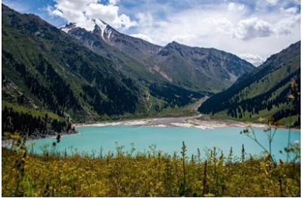 Big Almaty Lake is a natural alpine reservoir located in the Trans-Ili Alatau Mountains, 15 km (9.3 mi) south of Almaty in Kazakhstan. The lake flows into the Big Almaty River and is part of the Ile-Alatau National Park. Depending on the time of the year, the color of the lake changes from light green to turquoise blue.