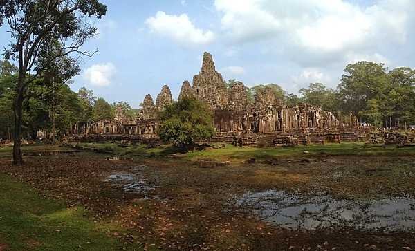 The Bayon is a richly decorated Khmer temple at Angkor, Cambodia, best known for the multitude of serene and smiling stone faces on its many towers. The temple  was built in the late 12th and early 13th centuries by King Jayavarman VII.
