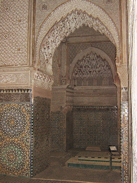 The Saadian Tombs are a historic royal necropolis in Marrakech, Morocco, that date to the time of the Saadian Dynasty (1549-1659). They are located on the south side of the Kasbah Mosque, inside the royal kasbah (citadel) district of the city. This view offers a glimpse into the Chamber of the Three Niches from the main mausoleum.