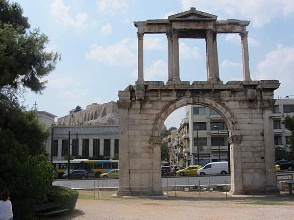 Hadrian's Arch in downtown Athens, Greece, was built in A.D. 131 or 132 to honor the Roman Emperor Hadrian, possibly for restoring much of the city and completing the nearby Temple of Olympian Zeus. The Parthenon and Acropolis can be seen in the left background.