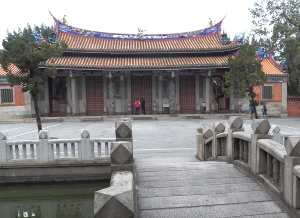 The Confucius Temple is located in the Datong District of Taipei. The original temple, built in 1879, was destroyed during the Japanese era (1895-1945). The temple was rebuilt in 1930, but during WW II traditional Chinese ceremonies were suspended by the Japanese until Taiwan was handed back to the Republic of China in 1945. The temple is modeled after the original Confucius Temple in Qufu, Shandong.  Among the Confucius temples in Taiwan, Taipei's is the only one adorned with southern Fujian-style ceramic applique.  The main hall of the temple contains a black plaque with a quote by Chiang Kai-shek in gold lettering that reads: "Educate without Discrimination."