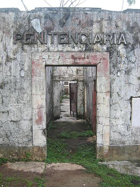 The ruins of a jungle prison on the island of Coiba in Panama.  The entire island was once a penal colony, but is now a nature reserve. The last few prisoners, who have no other home, tend the ruins of the main prison grounds.