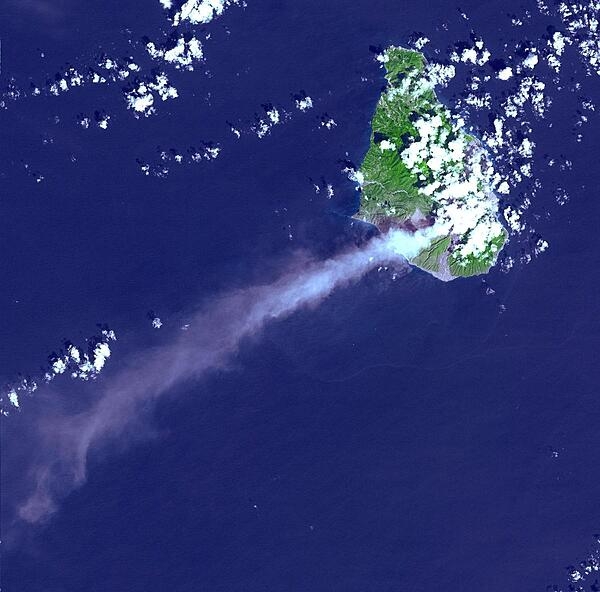 Eruptive activity of the Soufriere Hills Volcano on Montserrat is evidenced by an extensive smoke and ash plume streaming towards the west-southwest (image taken 29 October 2002). Significant eruptive activity began in 1995, forcing the authorities to evacuate about two-thirds of the island&apos;s original population of 12,000, and to close off the southern portion of the island. Image courtesy of NASA.