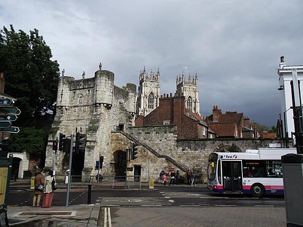 Bootham Bar (meaning "gatehouse") is part of the ancient city walls of York, United Kingdom, and has some of the oldest surviving stonework in the city, dating to the 11th century A.D. It was built on the site of the northwestern gate of Eboracum, the earlier Roman settlement. This view shows York Minster, the city's famous cathedral, in the background.