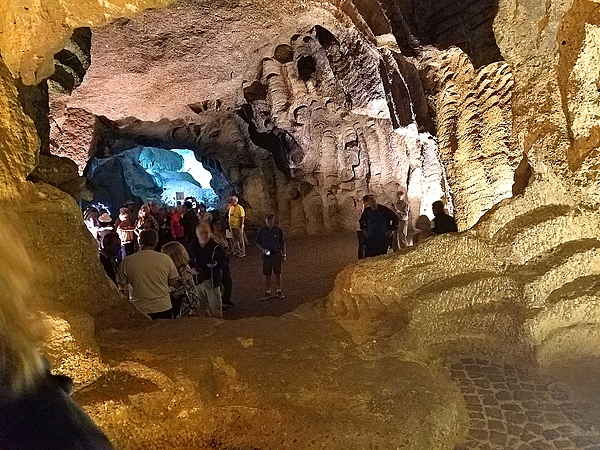 The interior of the Hercules Caves near Tangier, Morocco.  The caves are part natural and part man-made. Amazigh people used the man-made section to cut stone wheels from the walls to make millstones, expanding the caves considerably. The lower-right part of the photo shows evidence of millstone cutting.