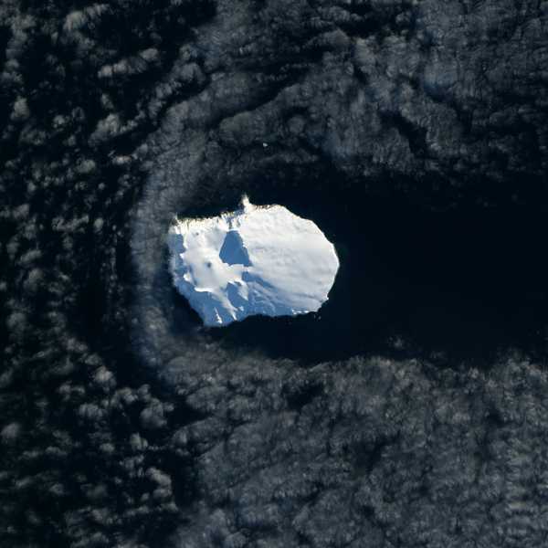 There is perhaps no better place to get away from it all than Norway’s Bouvet Island. Located in the South Atlantic Ocean between Africa, South America, and Antarctica, this uninhabited, 49-square-kilometer shield volcano is one of the most remote islands in the world. The nearest large land mass is the Princess Astrid Coast of Queen Maud Land, Antarctica—1,700 kilometers to the south. The nearest inhabited place is Tristan da Cunha, a remote island 2,260 kilometers to the northwest that is home to a few hundred people. On 26 May 2013, the Landsat 8 satellite acquired this natural-color image of Bouvet Island. Thick ice covers more than 90 percent of the island year round. Christensen glacier drains the north side; Posadowsky glacier drains the south side. A ring of volcanic black sand beaches encircles most of the island. In many areas, the thick layer of ice stops abruptly at the island’s edge, forming steep ice cliffs that plunge to the beaches and oceans below. Photo courtesy of NASA.