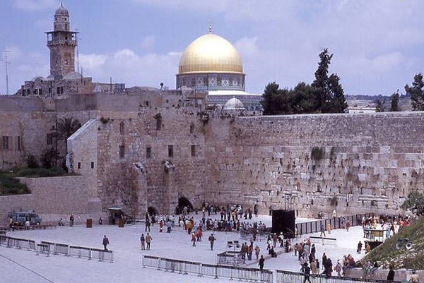 A view of the Western Wall (also known as the Wailing Wall or Buraq Wall) with the Dome of the Rock located above it. Both sites are in East Jerusalem.