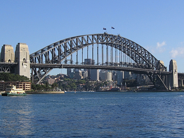 The Sydney Harbour Bridge is a steel through-arch bridge across Sydney Harbour that carries rail, vehicular, bicycle, and pedestrian traffic between the Sydney central business district and the North Shore. The bridge was opened in 1932; it is the world's widest long-span bridge and tallest steel arch bridge.