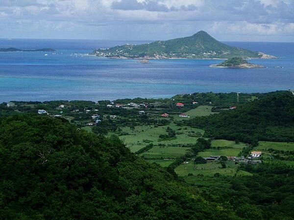 Photo taken from the island of Carriacau, part of Grenada. The island visible on the horizon is Petit Martinique, also part of Grenadan territory.