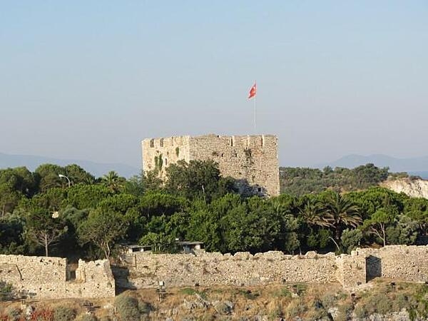 View of the restored castle on Pigeon Island (Guvercin Adasi) in the harbor of Kusadasi, Turkey. The fortress was the center of the town's activities in the late 19th century.