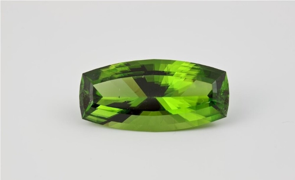 Peridot is one of the few gemstones that occurs in only one color, olive green. The peridot pictured is a modified barrel-cut 46.16-carat stone and the largest peridot from Pakistan in the Smithsonian Natural History Museum. The Egyptians first discovered the gemstone over 3,500 years ago.  (Picture courtesy of the Smithsonian Natural History Museum/Ken Larson.)