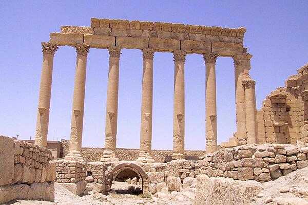 Temple ruins at Palmyra in central Syria. Palmyra has a long history extending back at least to the early second millennium B.C. The city changed hands between different empires on a number of occasions before becoming a subject of the Roman Empire in the first century A.D. Palmyra accumulated great wealth as a nexus for trade caravans, which then allowed for the construction of monumental building projects, many of which survive in a ruined state.