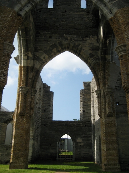 Bermuda’s “Unfinished Church” - what would have been St. George Church - fell victim to three events that precluded its use. The Gothic 650-seat church, designed by William Hay, began construction in 1874 as a replacement for the storm-damaged St. Peter’s church. During the construction the congregation split, which halted work on the church. Funds were later diverted to build a new cathedral in Hamilton after the old one burned down. Private donations finished the church in 1899, but the rejoined congregation returned to old St. Peter’s. In 1926, a storm damaged the church leaving it in its present condition.  The “Unfinished Church” is maintained by the Bermuda National Trust.